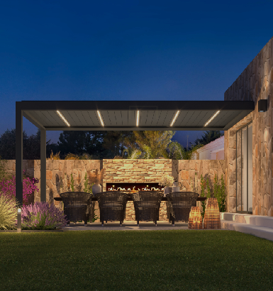 Louvred pergola sheltering an outdoor dining area at dusk